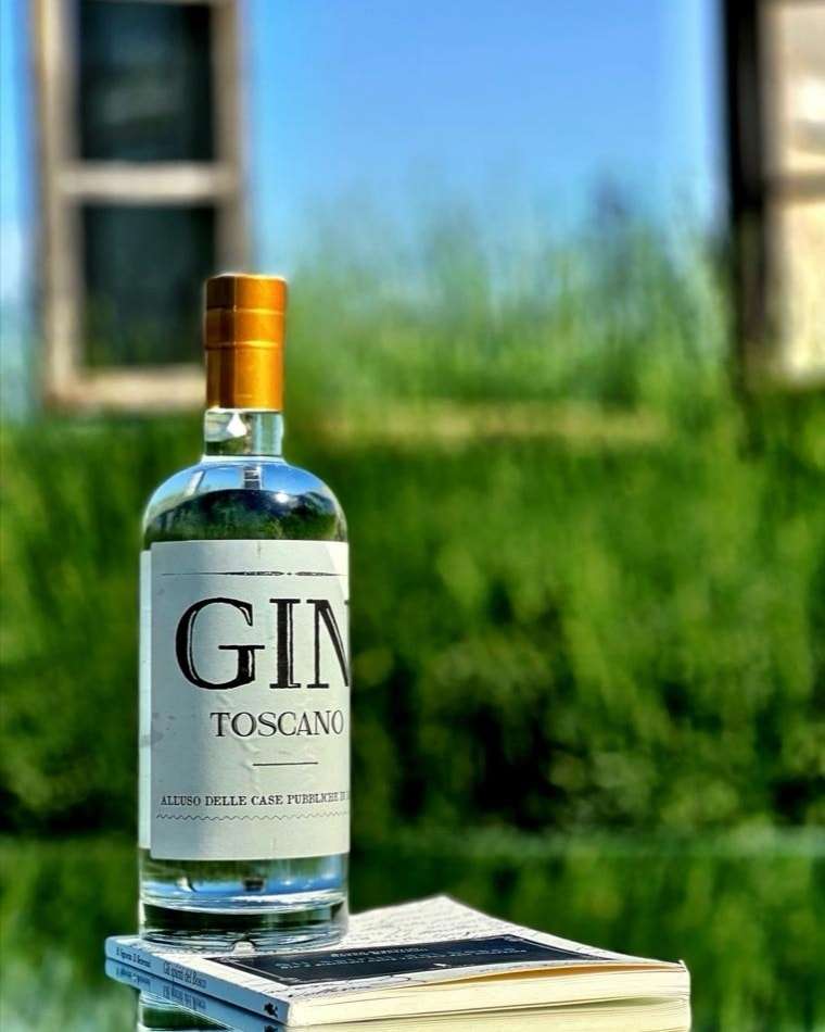 Bottiglia di Gin Toscano Spiriti del Bosco immersa nel paesaggio di Volterra